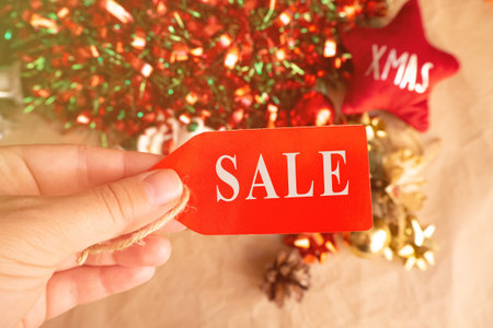 christmas tag with sale on xmas decoration with, christmas toys and balls. flat lay