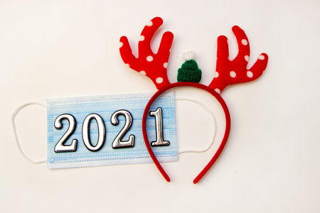 Festive christmas reindeer with face mask, decorations.Creative minimal concept of Christmas and New...