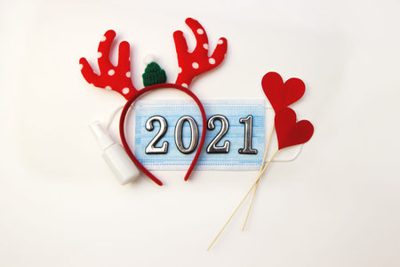 Festive christmas reindeer with antiseptic, hearts and face mask, decorations.Creative minimal...