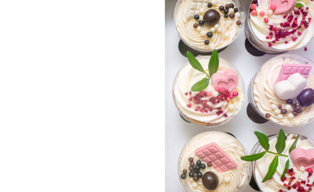 A lot of sweet small homemade trifle dessert with custard, chocolate, nuts and fruits and...