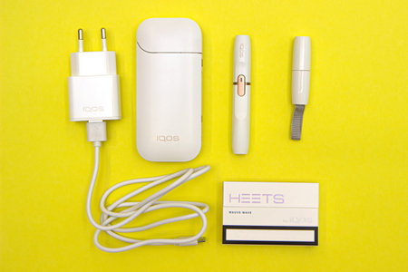 Minsk, Belarus - January 02, 2021: Electronic Cigarette Technology. Tobacco IQOS system. Close-up an electric hybrid cigarette with a Complete set, heating padのeditorial素材