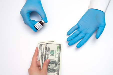 Coronavirus vaccine cost. vaccine ampoule in hand and money. Fight against Covid-19. Pevention,...