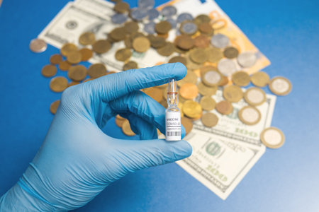 Coronavirus vaccine cost. vaccine ampoule in hand and money. Fight against Covid-19. Pevention,...