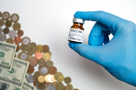 Coronavirus vaccine cost. vaccine ampoule in hand and money. Fight against Covid-19. Pevention,...