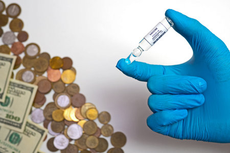 Coronavirus vaccine cost. vaccine ampoule in hand and money. Fight against Covid-19. Pevention,...