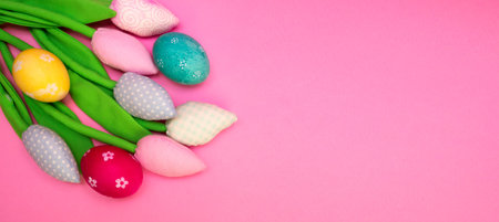 Easter background with painted eggs and colorful tulips. Top view with copy space. banner flatlyの写真素材