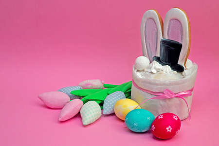 Easter creative cake with painted eggs and colorful tulips with copy space.の写真素材
