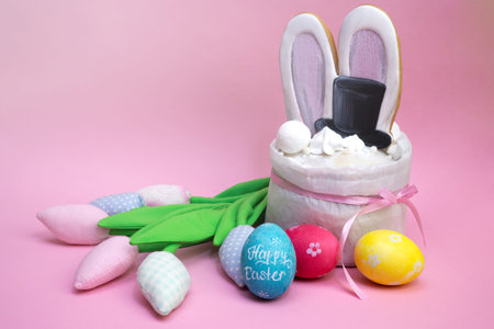Easter creative cake with painted eggs and colorful tulips with copy space.