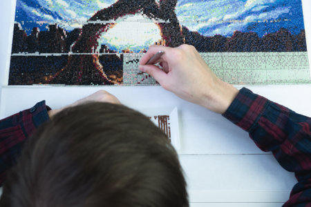 Diamond mosaic collection process. relaxation and rest from work in the process of monotonous activities. break for creativity and hobbiesの写真素材