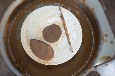 Dirty tools after working with clay on a potters wheel. painted heart