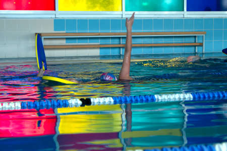 children unrecognizable group swimming freestyle style training in swimming pool with splashing waterの写真素材