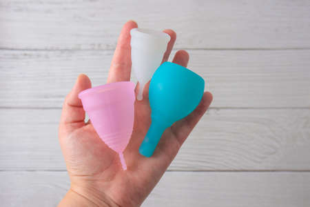 menstrual silicone cups different colors, shapes and capacity for menstruation cycle. Sustainable and comfortable menstruation cycle periods. Reusable eco friendly and zero waste hygiene products.の写真素材