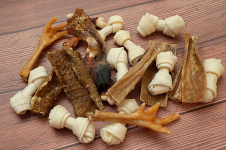 Various pile dried treats products for dogs. Meat products to feed and motivate dogs. Delicacy for teeth and protection against cariesの写真素材