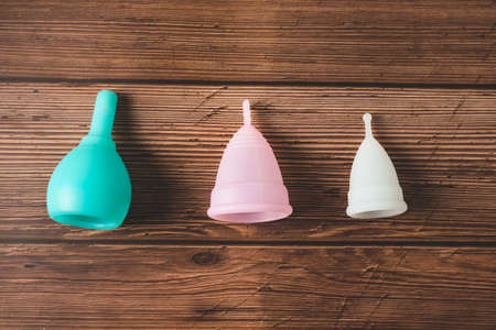 menstrual silicone cups different colors, shapes and capacity for menstruation cycle. Sustainable and comfortable menstruation cycle periods. Reusable eco friendly and zero waste hygiene products.の写真素材
