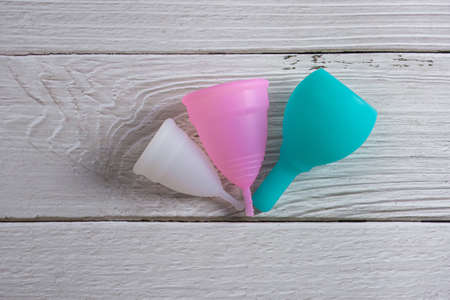 menstrual silicone cups different colors, shapes and capacity for menstruation cycle. Sustainable and comfortable menstruation cycle periods. Reusable eco friendly and zero waste hygiene products.の写真素材