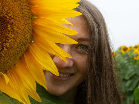 Portrait trendy stylish woman with sunflowers close up.の写真素材