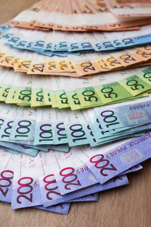 Belarusian paper money on wooden background. many colored currency of different denominations....