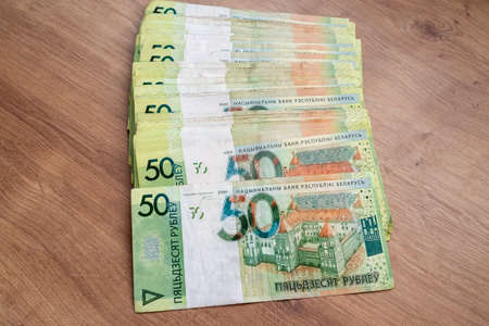 Belarusian paper money on wooden background. many colored currency of different denominations....