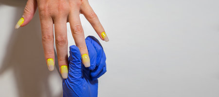 Hands of woman getting manicure treatment in beauty salon. Take care of yourself. Modern way of life. banner with copy spaceの写真素材