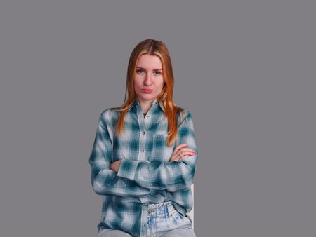Beautiful smiling woman with natural makeup wear fashion clothes looking emotionaly on gray...
