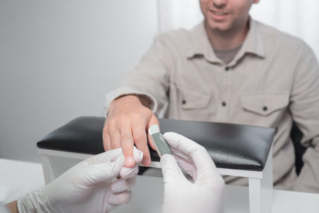 Japanese Manicure process for male nails in a beauty salon. Professional manicurist in gloves rubs...