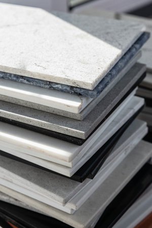 A stack of gray and white stone tiles is neatly piled. Concept of construction, renovation, or a...