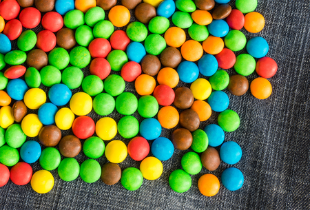 variety of candies on a jeans background with space for textの写真素材