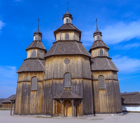 Old wooden church against the blue skyの写真素材