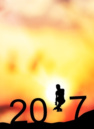 silhouette man jumps to make the word Happy New Year 2017 with sunrise