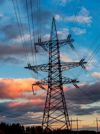 distribution electric substation with power lines and transformers, at a beautiful sunsetの写真素材