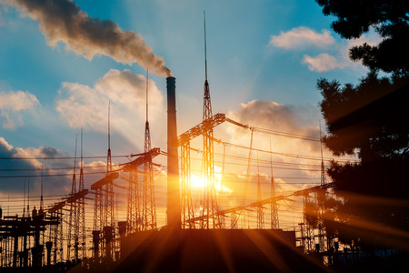 Gas turbine electrical power plant at dusk with orange skyの写真素材