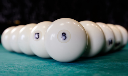 eight white billiard ball on a pool table