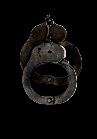 steel handcuffs of police special equipment, fetters on a black backgroundの写真素材