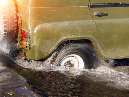 Splash of water from car tire, be careful to drive concept
