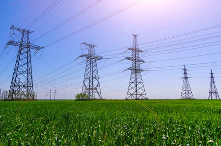 high-voltage power lines at sunset. electricity distribution station
