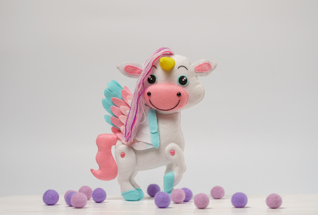 children's toy horse made of felt on a white background.の写真素材
