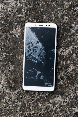 Broken mobile screen on the road or concrete floorの写真素材