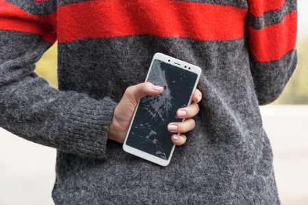 Smartphone with a broken screen. broken phone Close-up.の写真素材