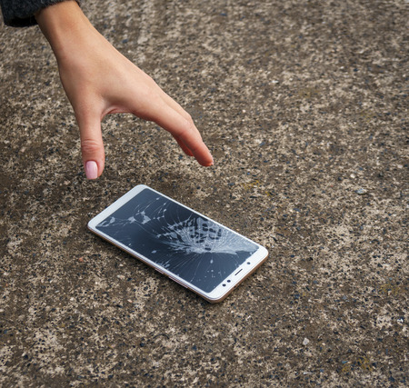 Smartphone with a broken screen. broken phone Close-up.の写真素材