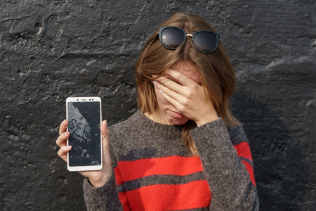 Smartphone with a broken screen. broken phone Close-up.の写真素材