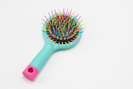 Bright colored hair comb on a white background. Close up.の写真素材