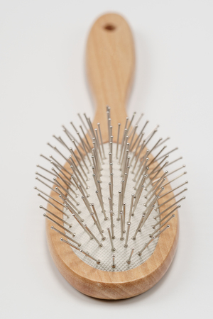 Wooden hair brush isolated on white background. Studio shot, close up.の写真素材