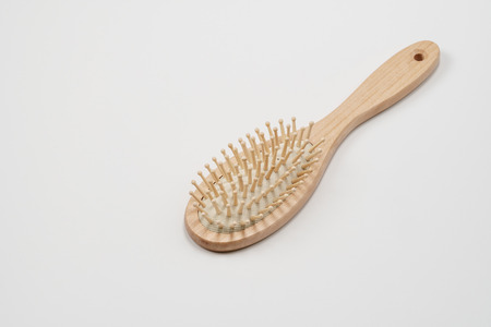 Wooden hair brush isolated on white background. Studio shot, close up. Natural eco friendly hair brushの写真素材