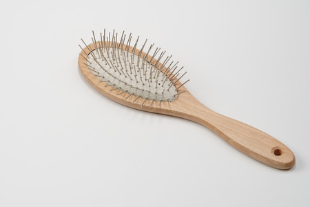 Wooden hair brush on white background. Studio shot, close up.の写真素材