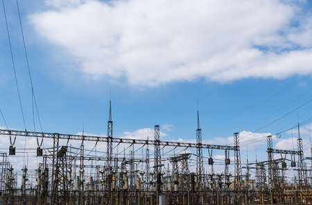 High power electricity poles in urban area. Energy supply, distribution of energy, transmitting energy, energy transmission, high voltage supply concept photo.の写真素材