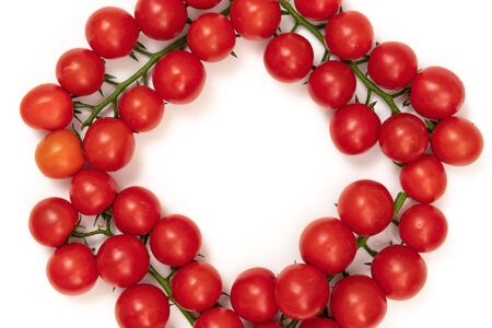 A branch of red cherry tomatoes on a white background. Small and juicy vegetable is rich in vitamins and trace elements. Healthy food. Fresh and organic vegetables. Raw food.の写真素材