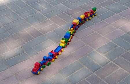 A train of various cars. A multi-colored toy train that rides towards adventure. A happy childhood...