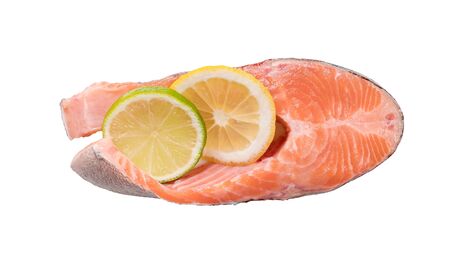 Steak of red fish, salmon with lemon, rosemary and thyme. Trout on white background. View from aboveの写真素材