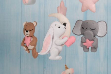 Baby crib mobile - kids toys, on light backgroundの写真素材