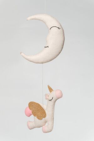 Baby crib mobile - kids toys, on light backgroundの写真素材